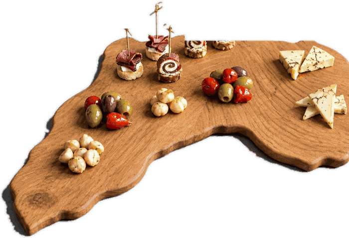 Africa shaped serving board in solid oak, laid with cheese, olives and charcuterie