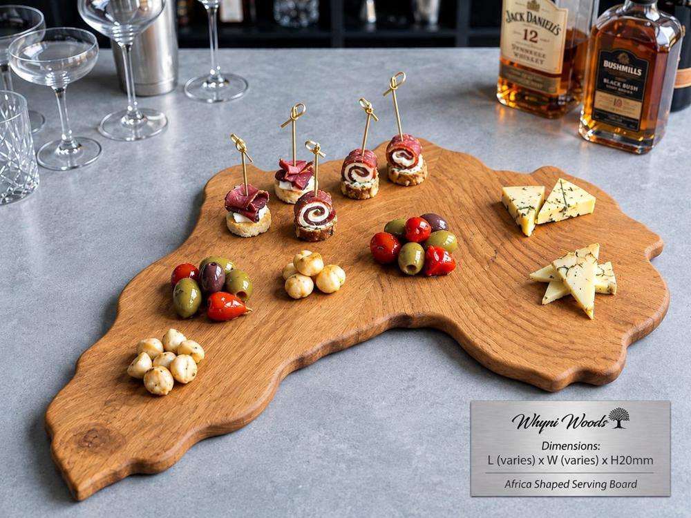 Africa shaped serving board in oak laid with cheese and olives