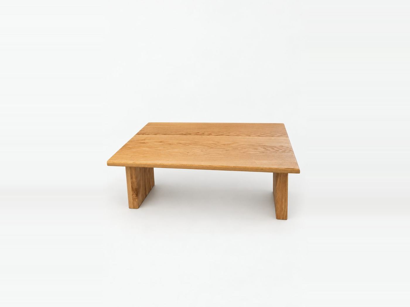 Low solid oak coffee table with wide slab legs