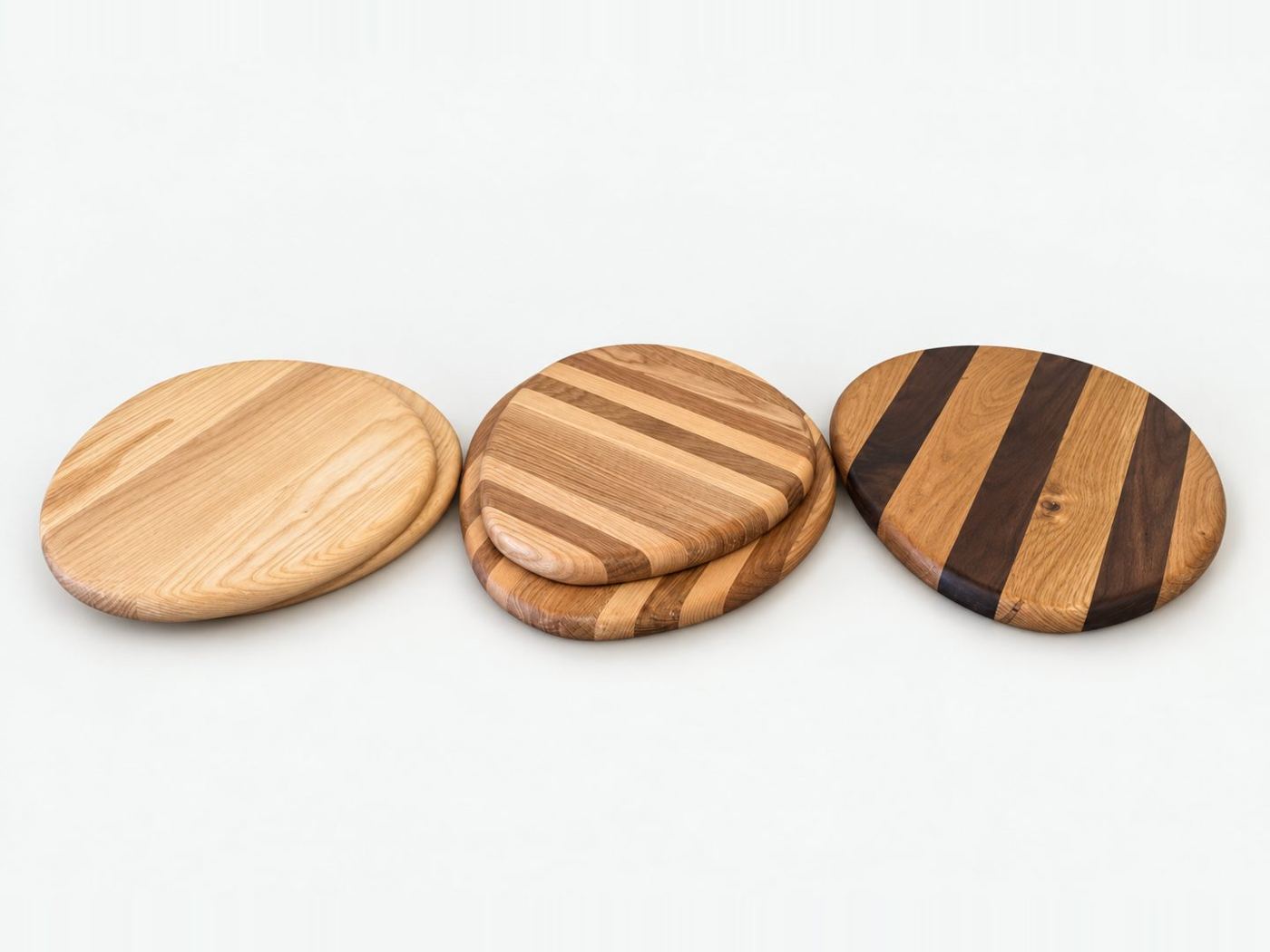 Three round serving boards, one plain and two with contrasting timber stripes