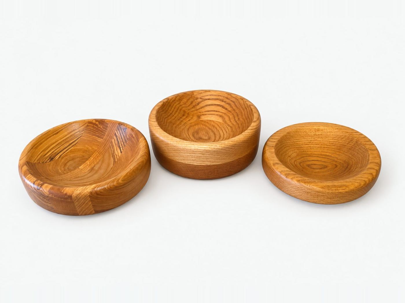 Three turned wooden bowls in oak and figured timber